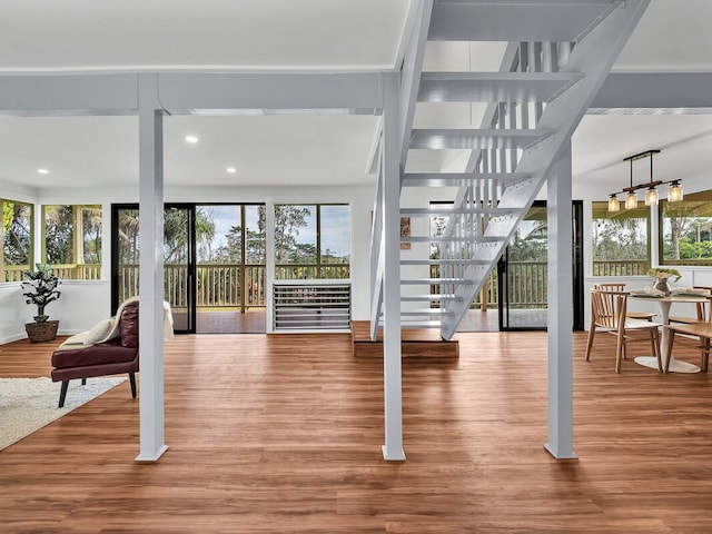 interior space featuring recessed lighting, wood finished floors, and stairs