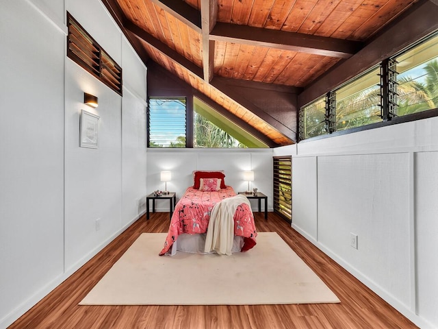 bedroom with wooden ceiling, vaulted ceiling with beams, and wood finished floors