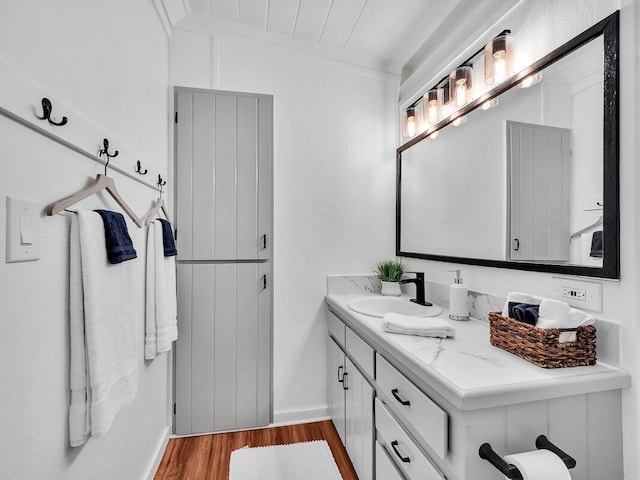 bathroom with wood finished floors and vanity