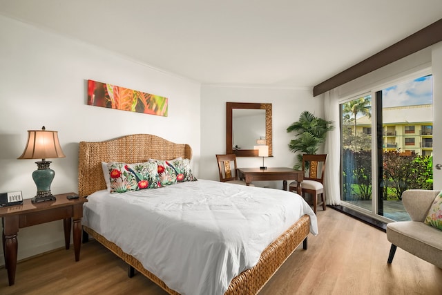 bedroom with light hardwood / wood-style floors and access to outside