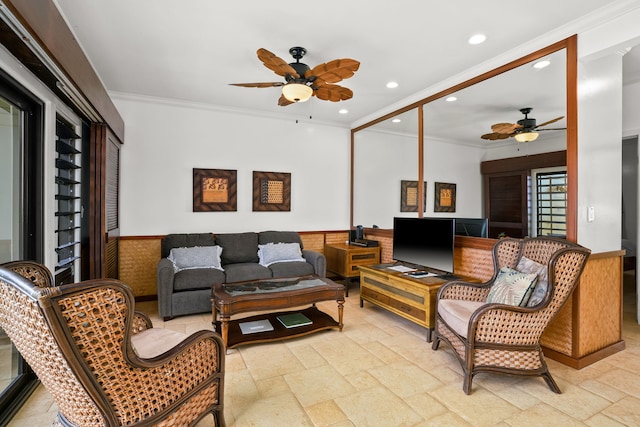 living room with ornamental molding and ceiling fan