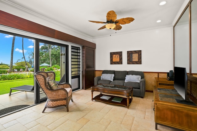 living room featuring crown molding and ceiling fan