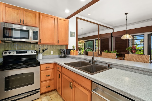 kitchen featuring sink, ornamental molding, a healthy amount of sunlight, and appliances with stainless steel finishes