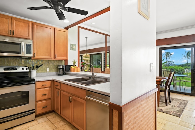 kitchen with sink, crown molding, ceiling fan, backsplash, and stainless steel appliances