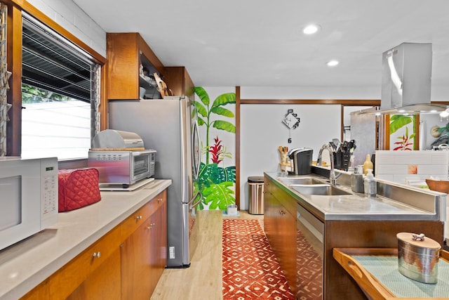 kitchen featuring island exhaust hood, sink, wine cooler, and stainless steel counters