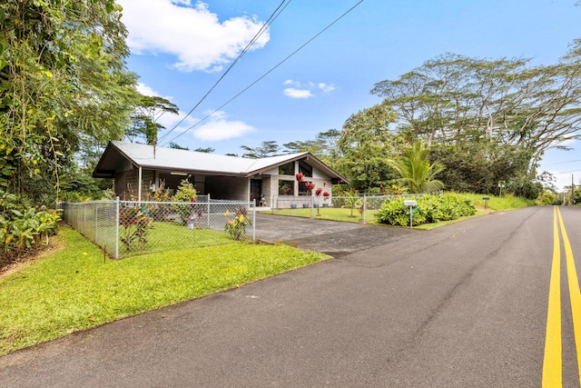 view of front facade with a carport and a front lawn