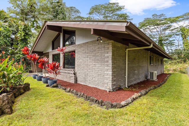 view of property exterior with a yard and ac unit