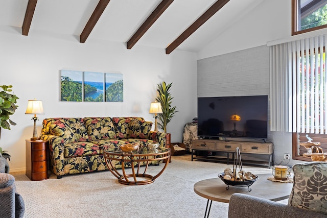 carpeted living room with beam ceiling and high vaulted ceiling