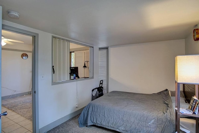 tiled bedroom featuring ceiling fan