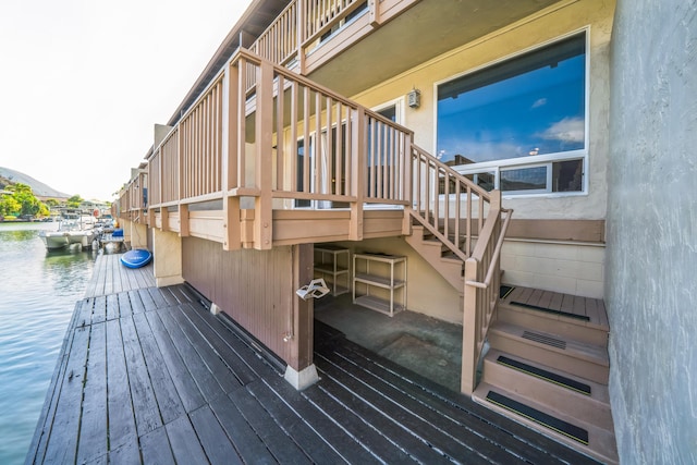 deck with a water view and a boat dock