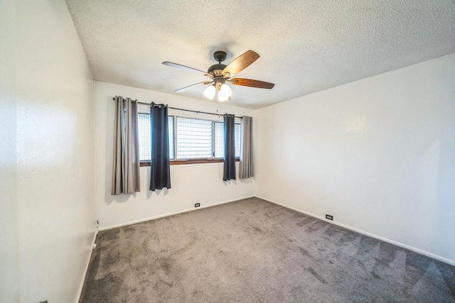 carpeted spare room featuring ceiling fan and a textured ceiling