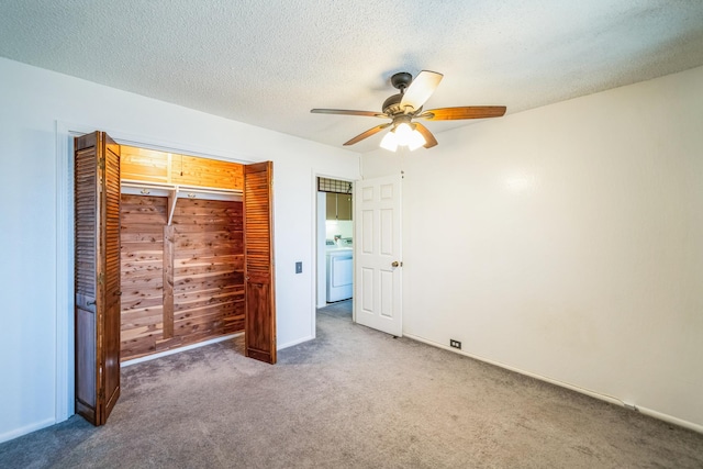 unfurnished bedroom featuring washer / clothes dryer, dark carpet, ceiling fan, a textured ceiling, and a closet