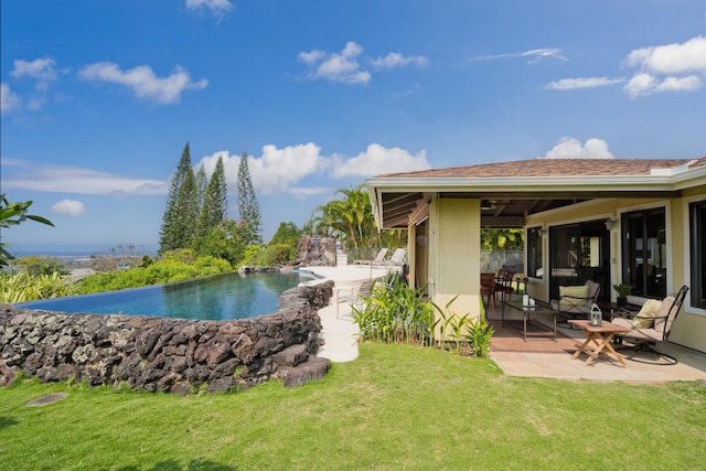 view of pool featuring a yard and a patio area