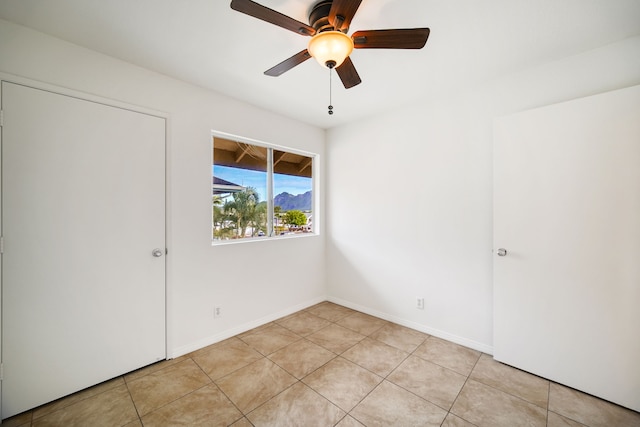 unfurnished bedroom featuring light tile patterned floors and ceiling fan