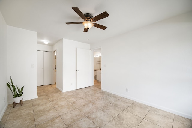 unfurnished bedroom with light tile patterned floors, a closet, and ceiling fan