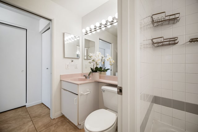 bathroom with vanity, tile patterned flooring, and toilet