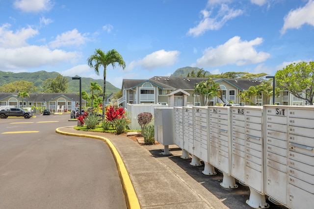 view of home's community with a mountain view and a mail area