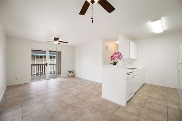 kitchen featuring dishwasher, light tile patterned floors, and white cabinets