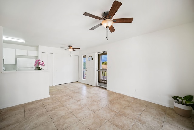 empty room featuring ceiling fan and light tile patterned flooring