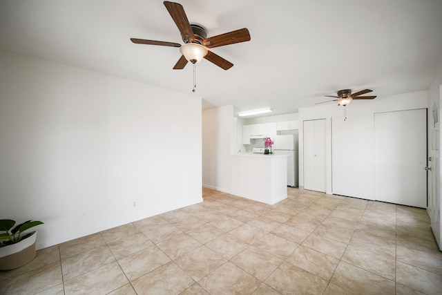 unfurnished living room with ceiling fan and light tile patterned flooring