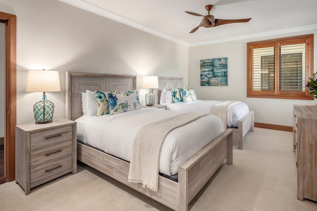 bedroom featuring ornamental molding, light colored carpet, and ceiling fan