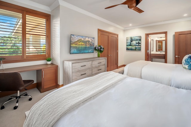 bedroom with light carpet, ensuite bath, ornamental molding, and ceiling fan