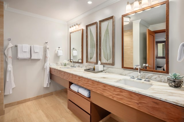 bathroom with vanity, wood-type flooring, and ornamental molding