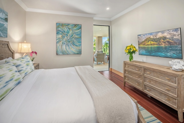 bedroom with crown molding, dark hardwood / wood-style floors, and access to outside