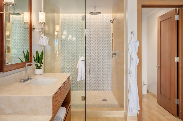 bathroom with vanity and a shower with shower door