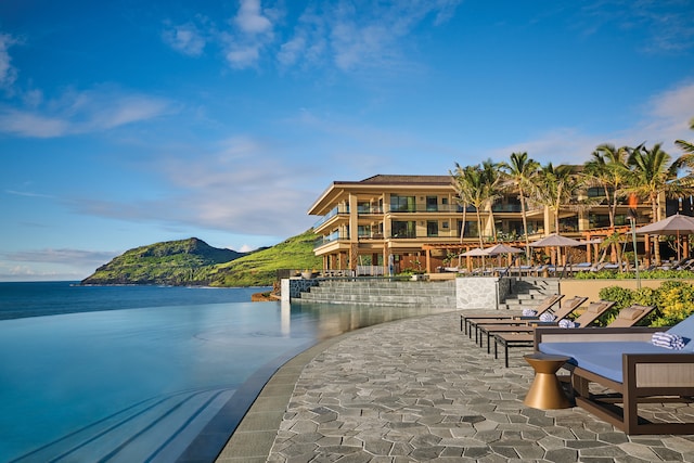 exterior space with a patio area and a water and mountain view