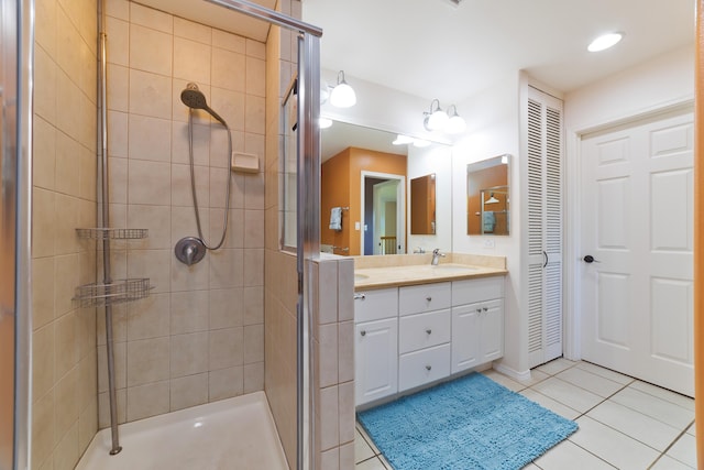 bathroom featuring tile patterned flooring, vanity, and walk in shower