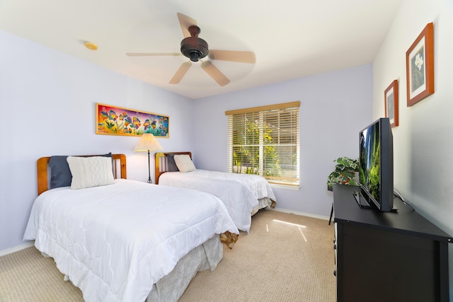 bedroom featuring light carpet and ceiling fan