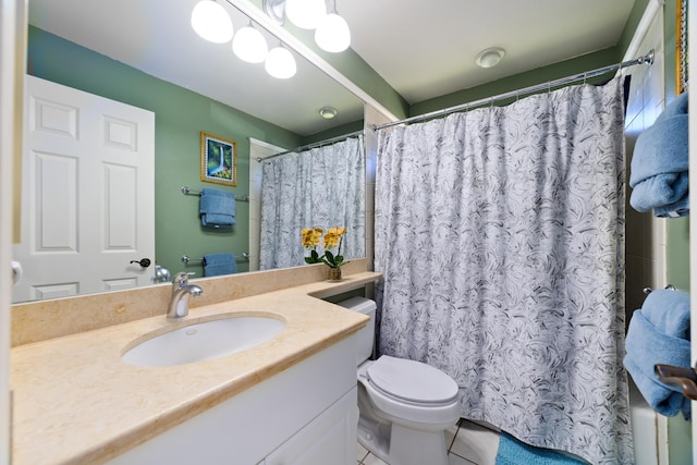 bathroom with vanity, curtained shower, tile patterned floors, and toilet