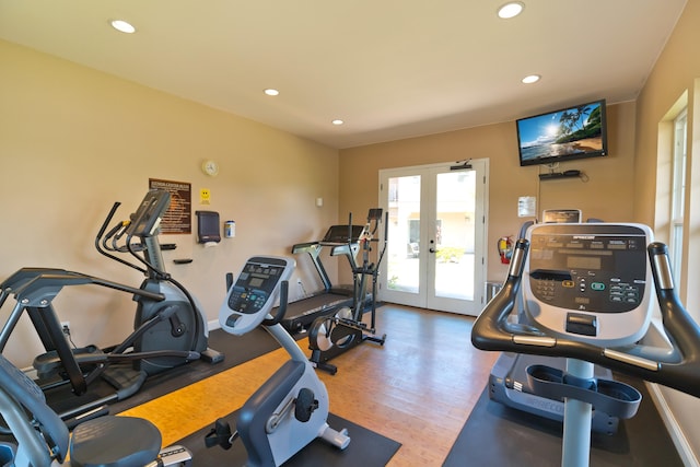 gym featuring hardwood / wood-style floors and french doors