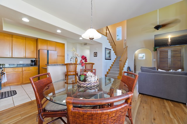 dining space featuring light wood-type flooring and a tray ceiling