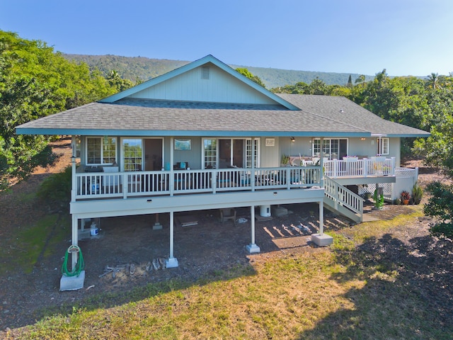 rear view of house with a yard and a deck