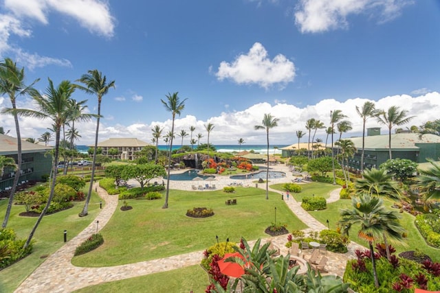 view of property's community featuring a water view and a yard