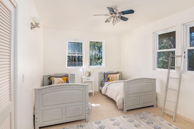 bedroom with light colored carpet and ceiling fan