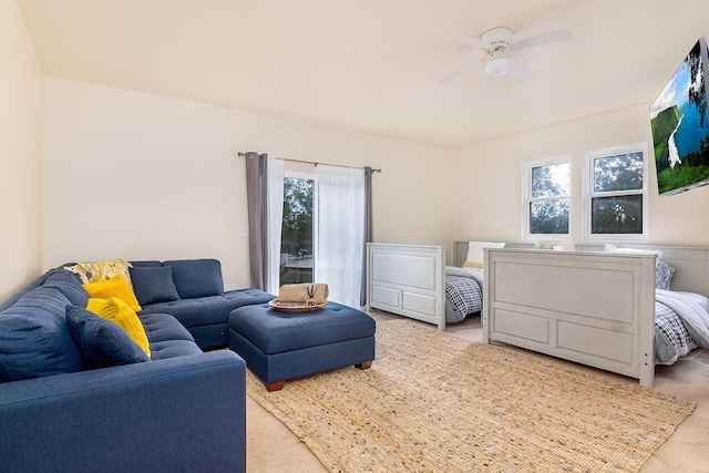 carpeted living room featuring ceiling fan and a wealth of natural light