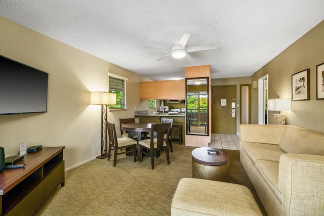 carpeted living room with a textured ceiling and ceiling fan