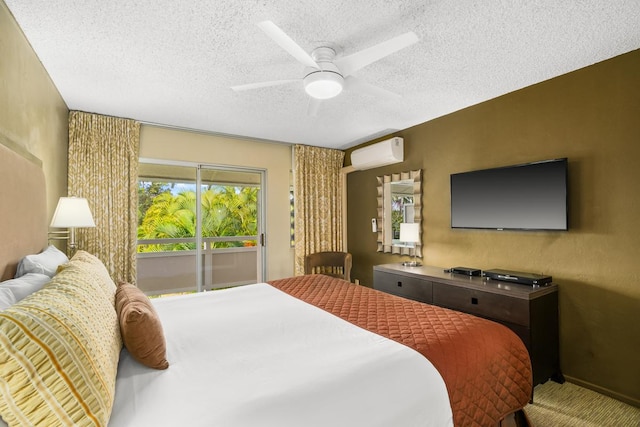 bedroom with ceiling fan, carpet floors, a wall unit AC, and a textured ceiling