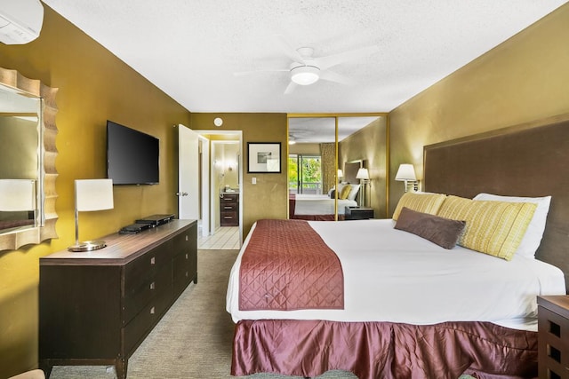 carpeted bedroom featuring a wall unit AC, a textured ceiling, ceiling fan, and a closet