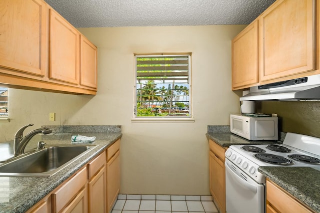 kitchen featuring light tile patterned flooring, sink, a textured ceiling, and white appliances