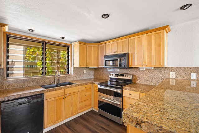 kitchen with a sink, tile counters, light brown cabinetry, dark wood-style floors, and black appliances