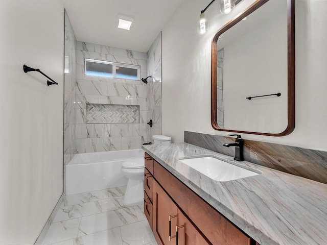 full bathroom featuring tiled shower / bath, vanity, and toilet