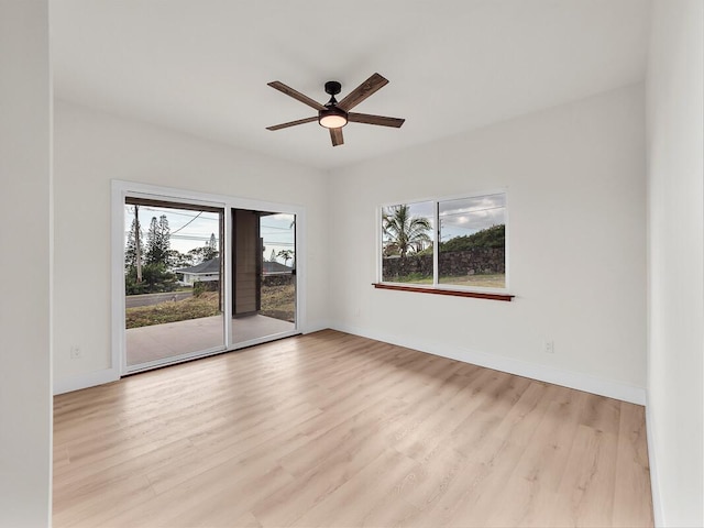 empty room featuring ceiling fan and light hardwood / wood-style flooring