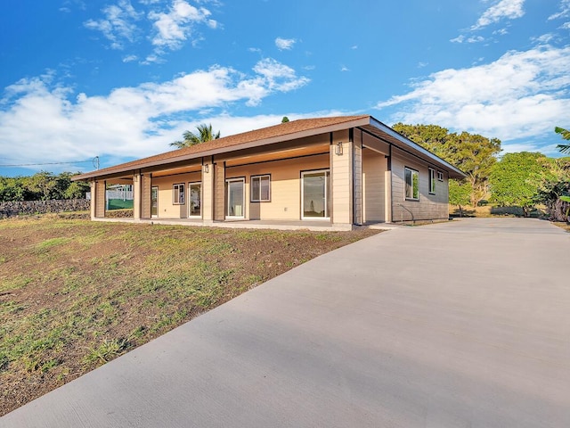 back of house featuring a yard and a patio area