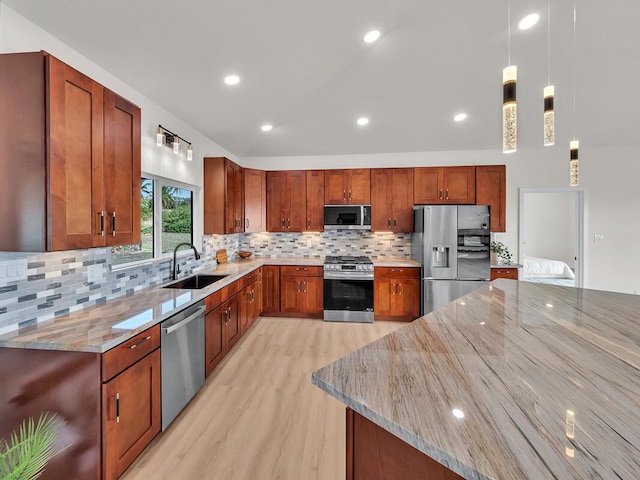 kitchen featuring sink, appliances with stainless steel finishes, backsplash, hanging light fixtures, and light stone counters