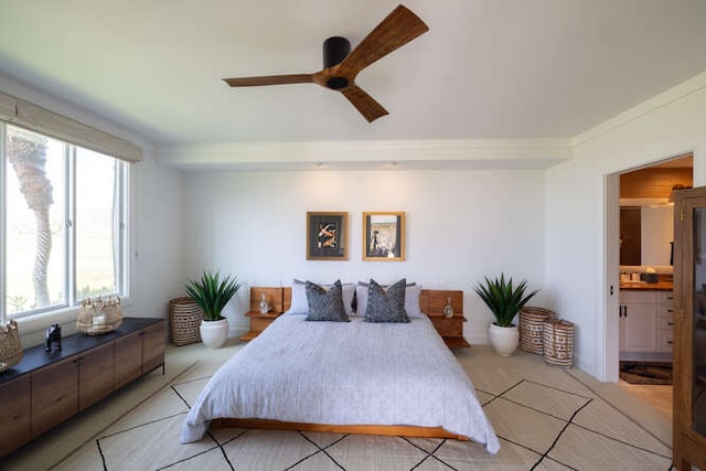 bedroom with ornamental molding, a ceiling fan, and ensuite bathroom