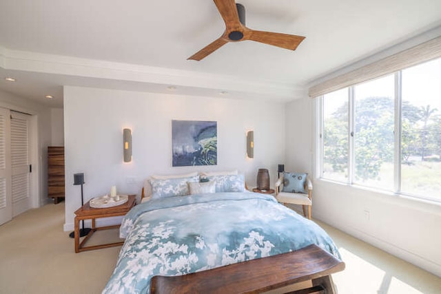 bedroom featuring light carpet and ceiling fan